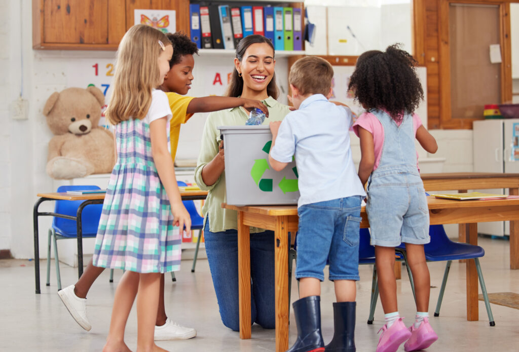 Shot of a young woman teaching a class of preschool children.